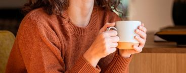 rapariga com uma chávena de café na mão