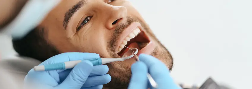 rapaz com erosão dentária em consulta no dentista