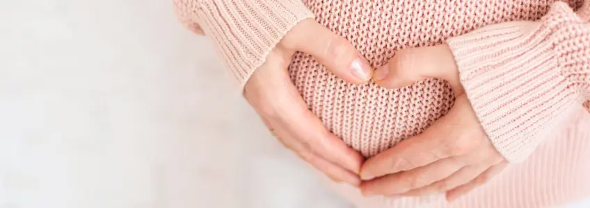 mulher grávida a tocar na barriga