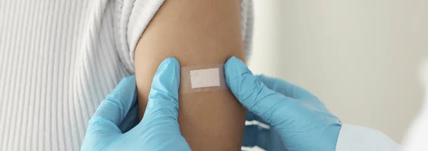 penso colocado no braço após vacina contra a gripe